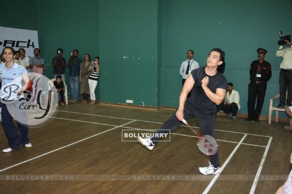 Aamir Khan and badminton ace Saina Nehwal play an exhibition match at launch of 'PULLELA GOPICHAND'Book in Mumbai