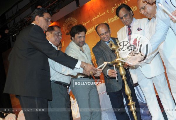 Chandru Punjabi, Govinda and Ram Jawhrani lighting up lamp at Mother Teresa Award