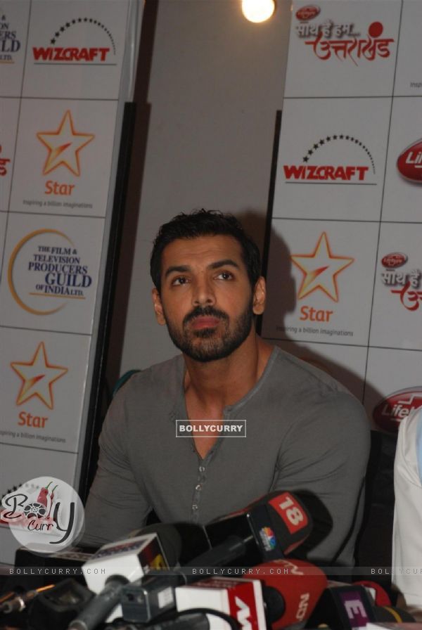 John Abraham patiently listens at the donation drive