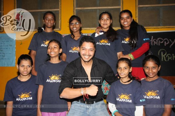 Shreyas Talpade shows off his Rakhis with his Rakhi sisters at the NGO