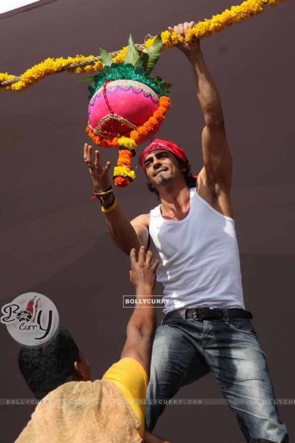 Arjun Rampal seen in as a Govinda, climbing up to the Dahi Handi