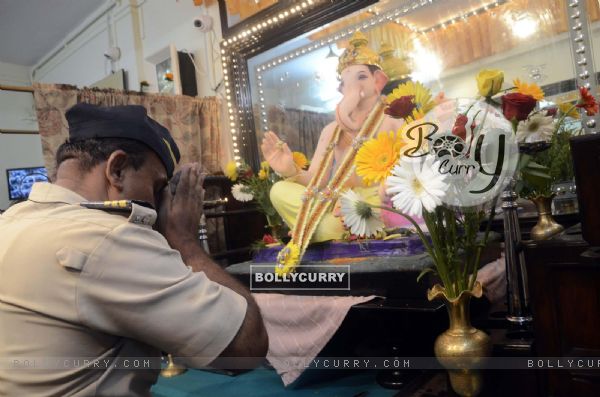 A constable seeks blessings of Lord Ganesha