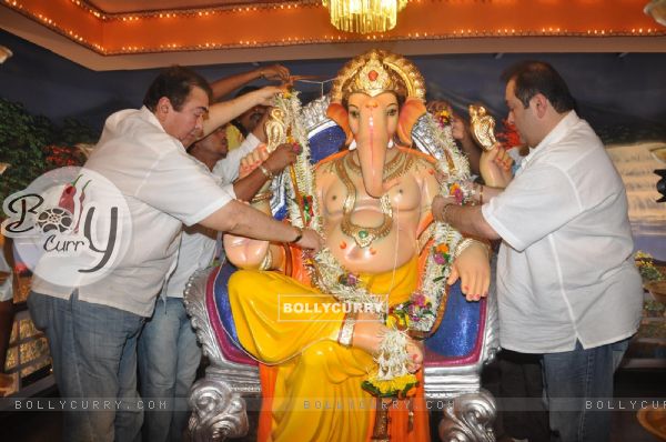 Randhir Kapoor and Rajiv Kapoor garland the idol of Lord Ganesha