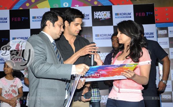 Sidharth Malhotra and Parineeti Chopra sign the autograph book at the Promotions of Hasee Toh Phasee
