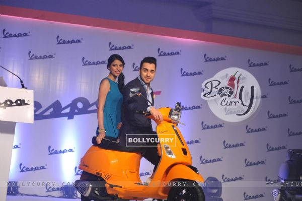 Imran Khan poses on the Vespa S with a fan