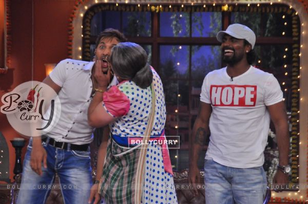 Dadi plants a kiss on Terence, while Remo watches this time