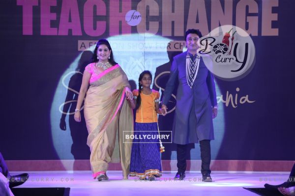 Guests with a child walk the ramp at the Teach for Change 2014 Fashion Show