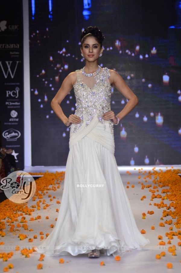 A model walks the ramp as a bride's maid at the IIJW 2014 - Day 2