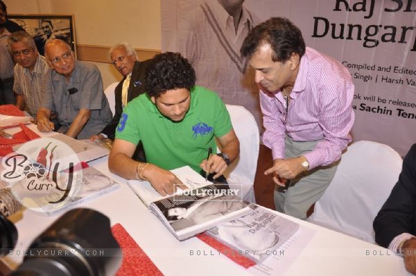 Sachin Tendulkar autographs a book at Durgapur Tribute Book Launch