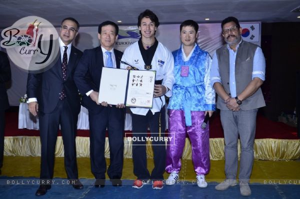Tiger Shroff receiving his award at the Kukkiwon Award Ceremony