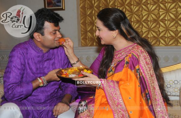 Poonam Dhillon gives her brother some sweets for Raksha Bandhan