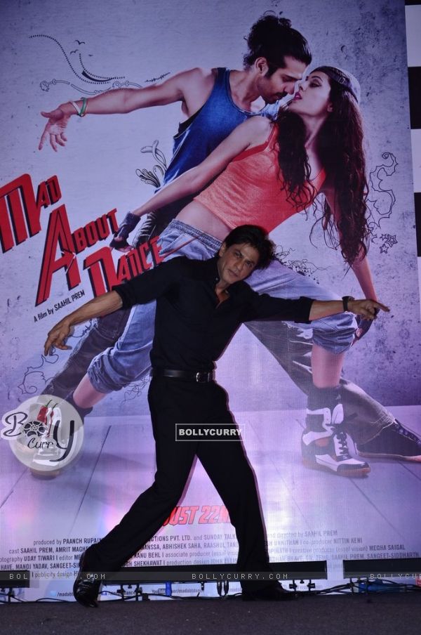 Shah Rukh Khan poses with the poster of Mad About Dance