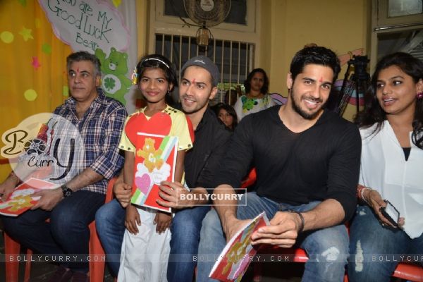 Varun Dhawan and Sidharth Malhotra pose with a kid at Ashray Ngo