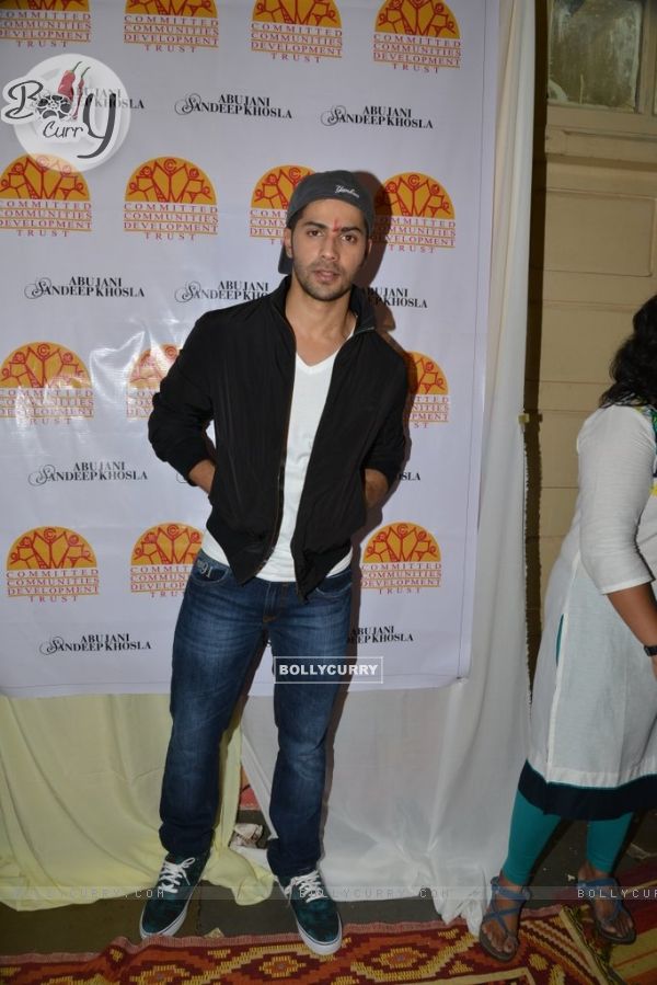 Varun Dhawan poses for the media at Ashray Ngo