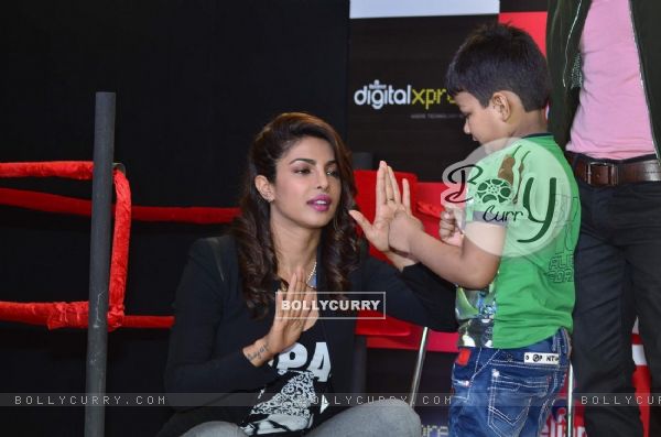 Priyanka Chopra teaches a young fan some boxing moves at the Promotions of Mary Kom (336837)