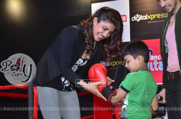 Priyanka Chopra gives an autographed boxing glove to a young fan at the Promotions of Mary Kom