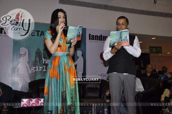 Kriti Sanon and Chetan Bhagat reading the book at the Book Launch of Half Girlfriend