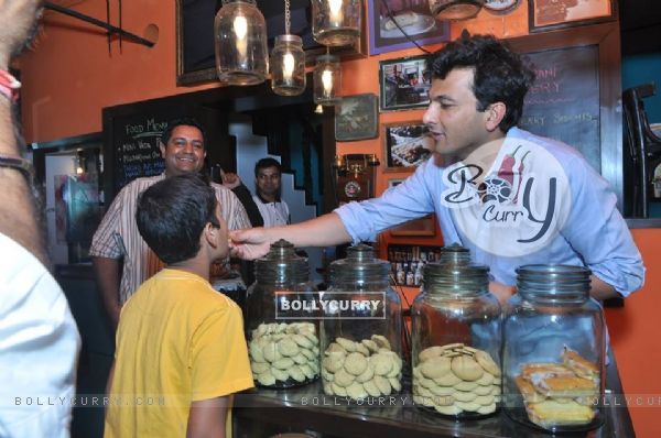 Vikas Khanna gives children some sweets at the Launch of Twist Of Taste - The Sweet Life