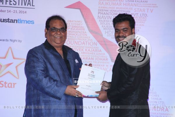 Satish Kaushik presents an award to a winner at the Closing Ceremony of 16th MAMI Film Festival