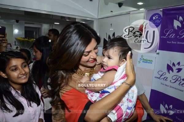Sushmita Sen plays with a kid at Dr. Trasi's Clinic Launch