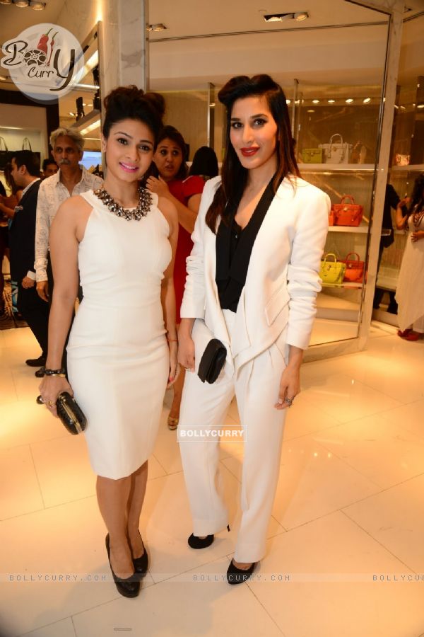 Sophie Choudry and Tanishaa Mukerji pose for the media at Michael Korrs Store Launch