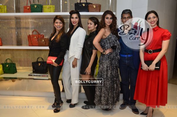 Celebs pose for the media at Michael Korrs Store Launch