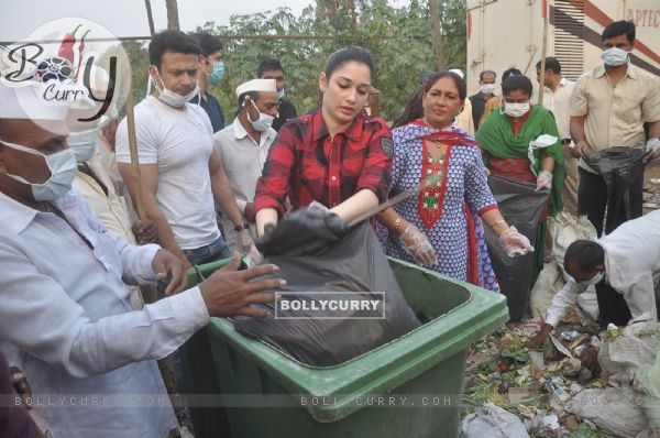 Tammanah unloads the garbage in a bin at a Cleanliness Drive