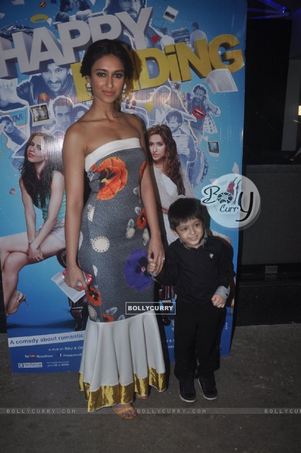 Ileana D'Cruz poses with a kid at the Special Screening of Happy Ending