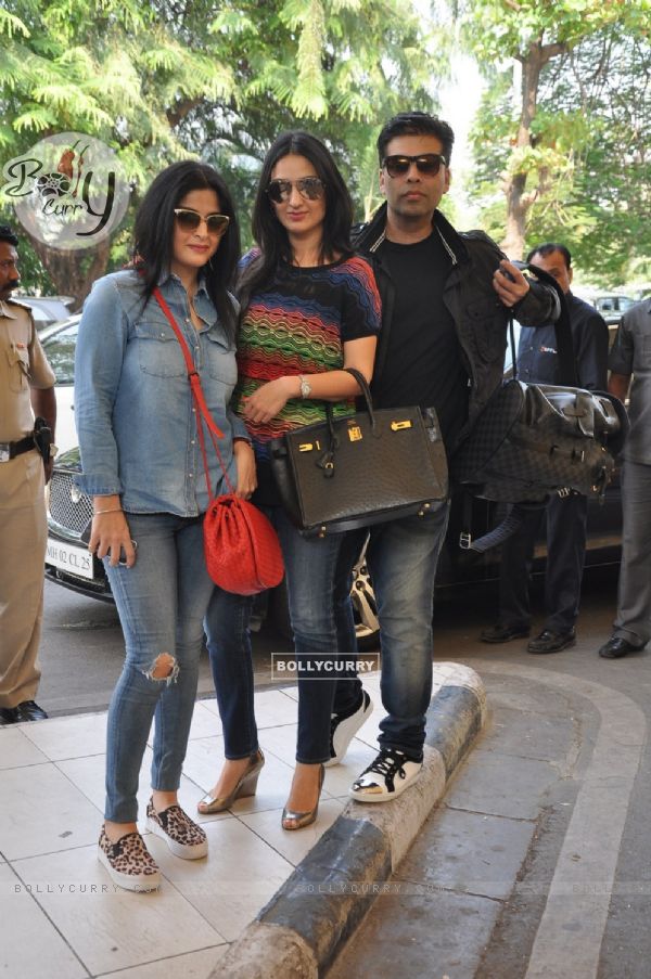 Karan Johar poses with friends at airport while leaving for Arpita Khan's Wedding