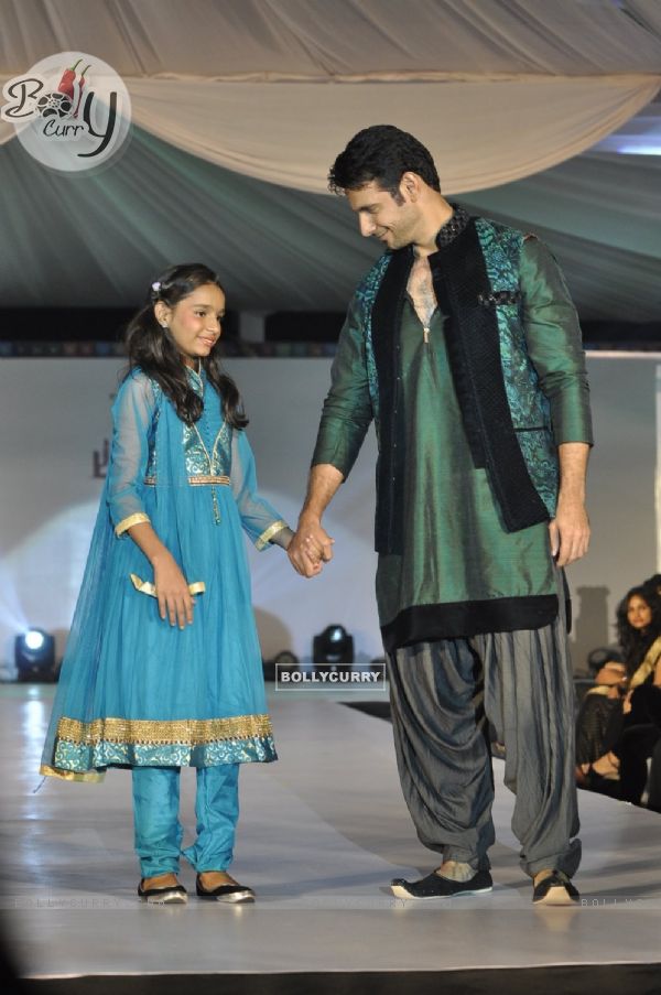 Viraf Phiroz Patel walks the ramp with a small girl at Wellingkar's 26/11 Tribute
