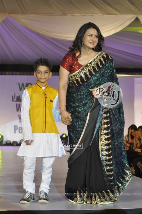 Poonam Dhillon walks the ramp with a small boy at Wellingkar's 26/11 Tribute