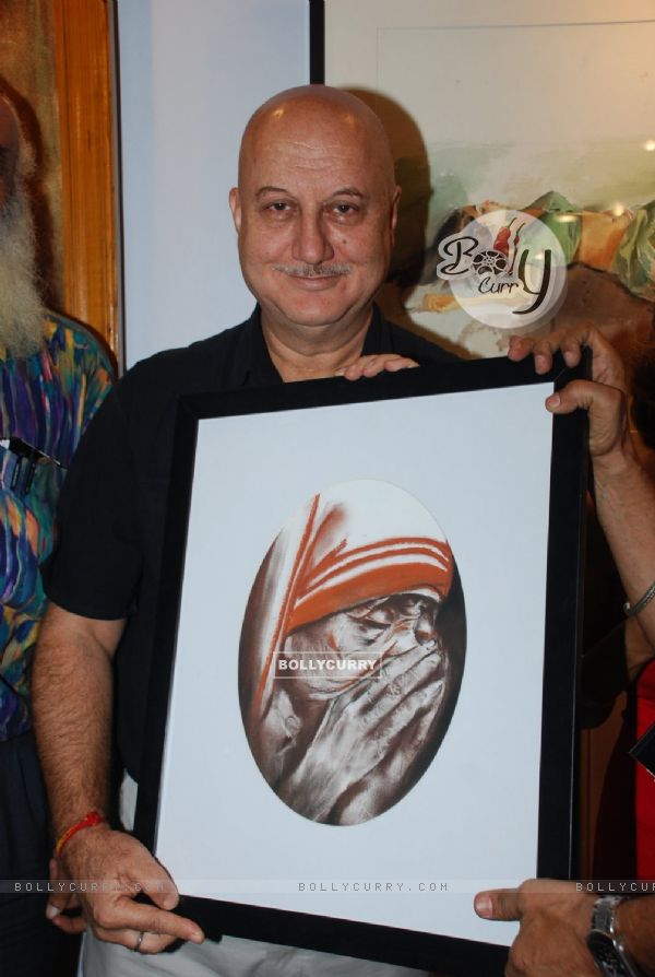 Anupam Kher poses with the potrait of Mother Teresa at the Inauguration of India Art Festival
