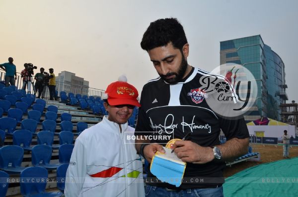 Abhishek Bachchan signs autograph for a young fan at Barclays Premier League