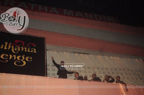 Shah Rukh Khan climbs the wall at Maratha Mandir and makes his signature pose during the Celebration