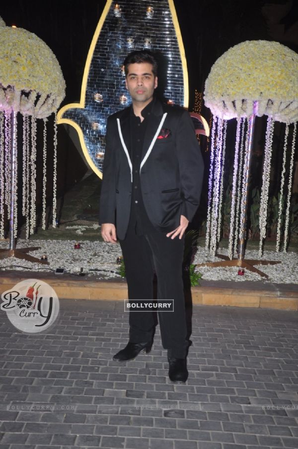 Karan Johar poses for the media at the Wedding Reception of Riddhi Malhotra and Tejas Talwalkar