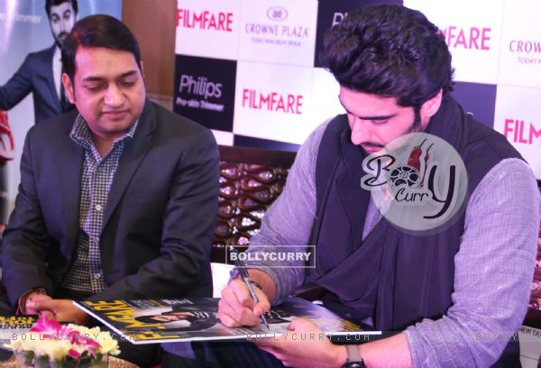 Arjun Kapoor signs his autograph on the Latest Issue of Filmfare Magazine