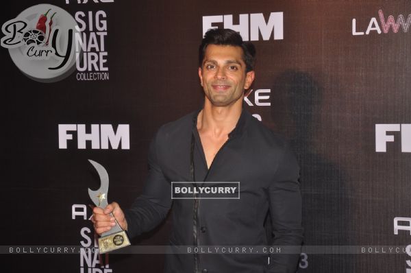Karan Singh Grover poses with his award at FHM Bachelor of the Year Bash