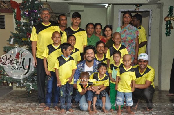 Ali Fazal poses with Ngo Kids at the Christmas Celebrations