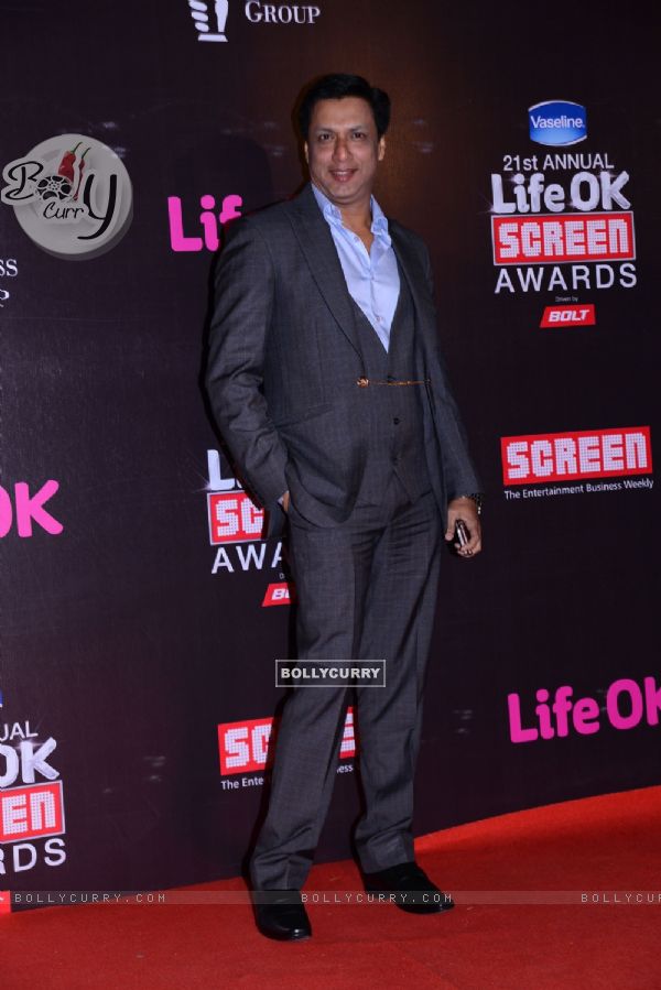 Madhur Bhandarkar poses for the media at 21st Annual Life OK Screen Awards Red Carpet
