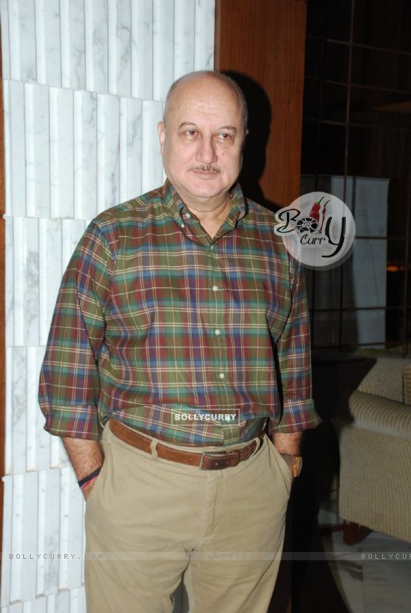 Anupam Kher poses for the media at Arya Babbar's Book Launch