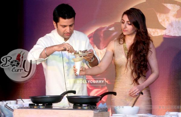 Chef Kunal Kapur prepares a dish for Soha Ali Khan at Magnum Promotional Event