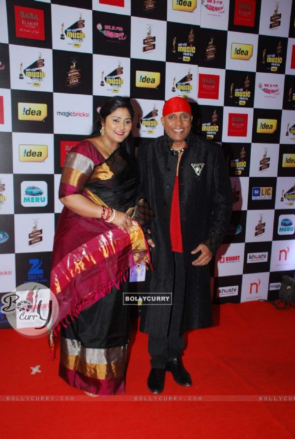 Anandan Sivamani poses with wife at Radio Mirchi Awards