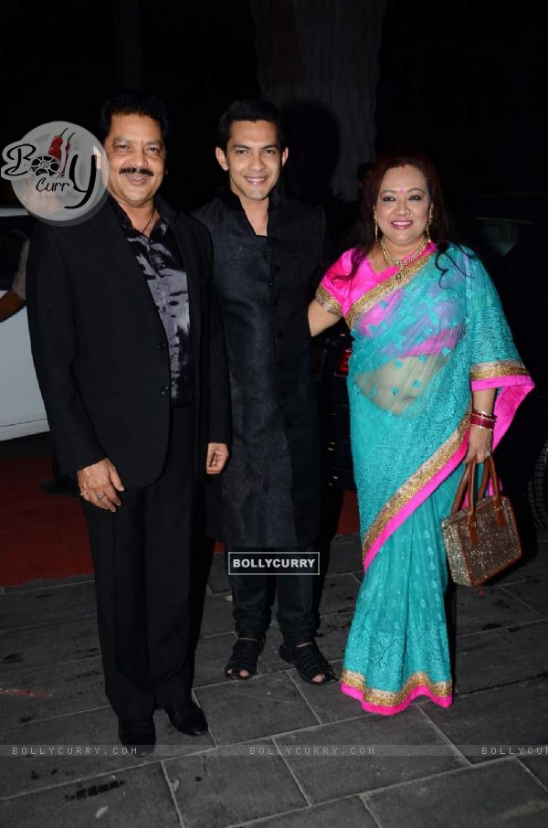 Aditya Narayan poses with his Parents at Tulsi Kumar's Wedding Reception