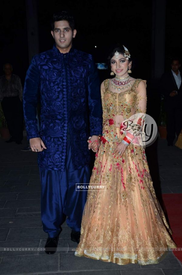 Tulsi Kumar and Hitesh Rahlan pose for the media at their Wedding Reception