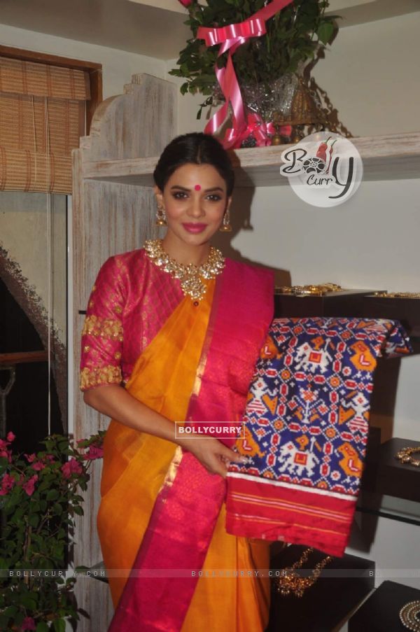Sara Loren poses with a saree design at the Launch of Vedaa Store
