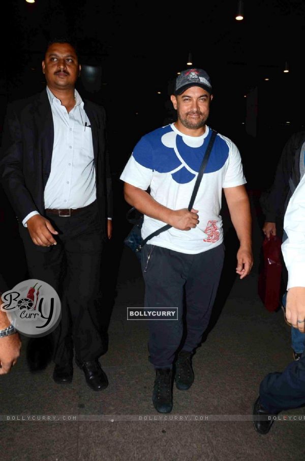 Aamir Khan poses for the media while returning from Disneyland Trip