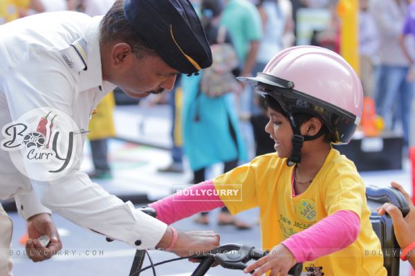 Cop interacts with a kid at 'Safe Kids Day' Event
