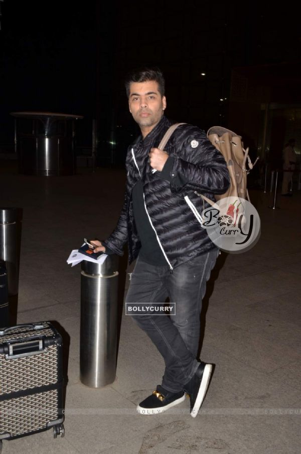 Karan Johar poses for the media at Airport