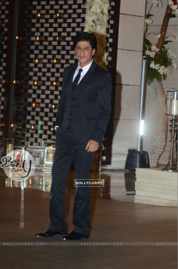 Shah Rukh Khan poses for the media at Mukesh and Nita Ambani's Bash