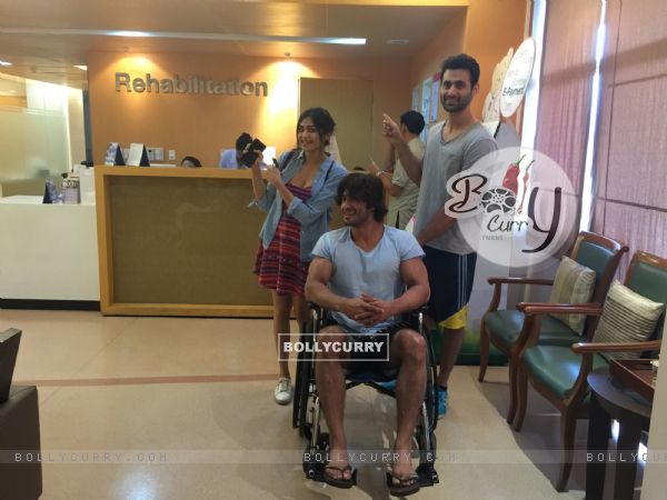Picture of Vidyut Jamwal who is seen sitting on a wheelchair accompanied by his co-stars.